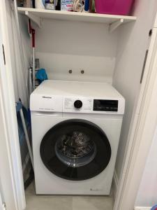 a white washer and dryer in a closet at Sweet home deluxe in Playa de las Americas