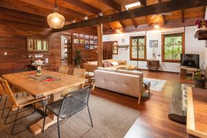 a living room with a table and a couch at The Enchanted Stone Cottage in Margaret River Town