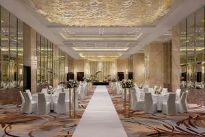 a banquet hall with white tables and white chairs at The Westin Singapore in Singapore +115 photos