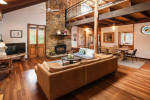 a living room with a couch and a fireplace at The Enchanted Stone Cottage in Margaret River Town