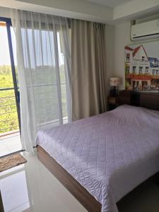 a bedroom with a bed and a large window at Cozy apartment with a sea view in Ban Bo Sai Klang +78 photos
