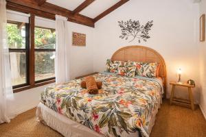 a bedroom with a bed with a wooden head board at The Enchanted Stone Cottage in Margaret River Town