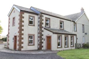 a large white house with a driveway at Sharp Edge in Penrith