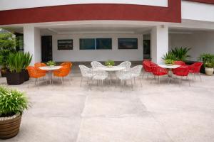 a patio with tables and chairs and potted plants at Bridge Residency River View Hotel Near Bridge,201 in Muzaffarabad +13 photos