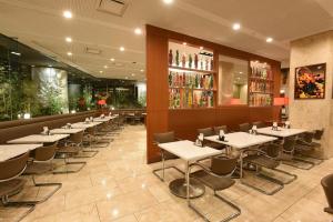 a row of tables and chairs in a restaurant at Fukuyama New Castle Hotel in Fukuyama