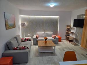 a living room with two couches and a coffee table at Aura in Gerakini