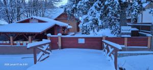 a gazebo with snow on top of it at Levente vendégház in Szilvásvárad