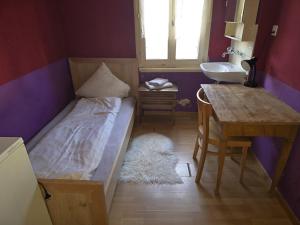 a bedroom with a bed and a sink and a table at Gasthasu Weisses Schäfli in Arbon