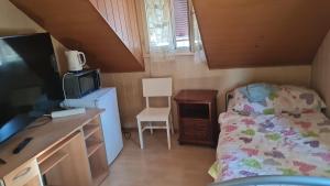 a small bedroom with a bed and a desk at Gasthasu Weisses Schäfli in Arbon