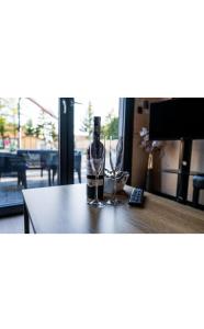 a bottle of wine and two glasses on a table at Lutek in Olsztynek