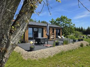 a house with a patio and an umbrella at Lutek in Olsztynek
