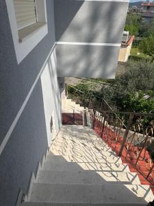 a stairway leading up to a building with a shadow at Villa 24 maj cole vlore in Vlorë