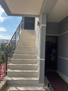 a stairway leading up to a house with a view at Villa 24 maj cole vlore in Vlorë +1 photo