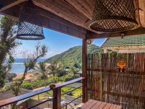 a view of the ocean from the porch of a house at Bamboo Room in Ponta do Ouro