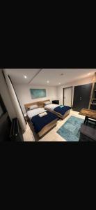 a large bedroom with two beds and a table at Studio 21 in Hasselroth