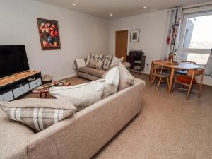 a living room with a couch and a table at Amber Rose in Berwick-Upon-Tweed