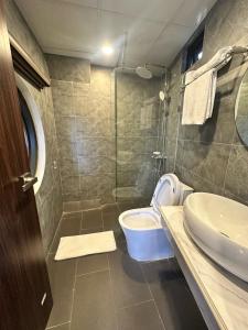 a bathroom with a toilet and a sink at Calla Lily Hotel in Sapa