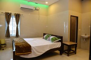 a bedroom with a bed and a sink in it at PNR CONVENTION hall in Jāmb