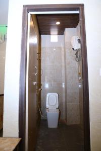 a bathroom with a toilet and a shower at PNR CONVENTION hall in Jāmb