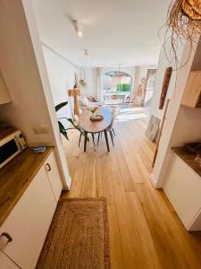a kitchen and living room with a table and a dining room at Nature LOFT MOLN in Kinrooi +18 photos