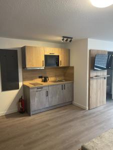 an empty kitchen with a sink and a microwave at Hotel Rammelkamp in Nordhorn +15 photos