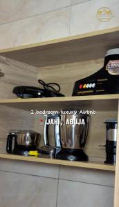 a pot on a stove on a shelf at AA Luxury Apartments in Abuja