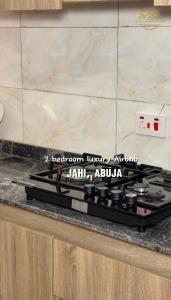a kitchen counter with a stove top in a kitchen at AA Luxury Apartments in Abuja +13 photos