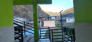 a view of a train station from a balcony at Omji Niwas - Kalindi in Kharsālī