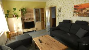 a living room with a couch and a table at Ferienwohnungen Markgraf in Dresden