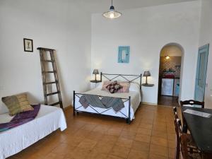 a bedroom with a bed and a ladder in it at Villa Paradiso - spectacular sea view over volcanoes in Piano Conte