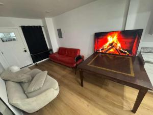 a living room with a fireplace and a couch at Vernon Vibes in Los Angeles