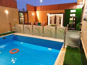a swimming pool with a red frisbee in it at شالية سحاب in Rayyis