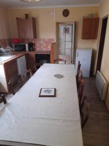 a kitchen with a table with a picture on it at la tute de l'ours in Roquefeuil