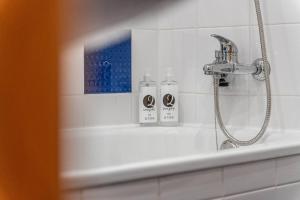 a bathroom with a shower with two bottles on the tub at Sapphire Scape Near Airport Madeira Santa Cruz in Gaula +47 photos