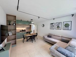 a living room with a couch and a table at Vinopool Suites Badacsony in Badacsonytomaj
