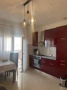 a kitchen with brown cabinets and a table with a dining room at Moko in Senj