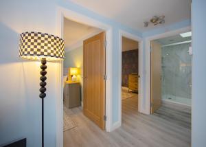 a room with a lamp and a hallway at Private 2 Bed Escape with Huge Parking in Ely +46 photos