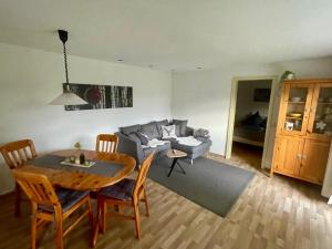 a living room with a table and a couch at Ferienwohnung Mutter in Schluchsee