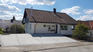 a white house with a large driveway at Ferienwohnung Mutter in Schluchsee +2 photos