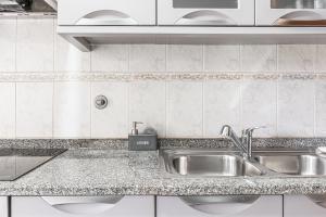 a kitchen with a sink and a counter top at Emerald Scape Garajau Madeira Cristo Rei Area in Caniço +27 photos