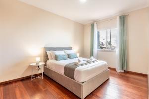 a bedroom with a large bed and a window at Emerald Scape Garajau Madeira Cristo Rei Area in Caniço
