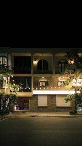 a large building with white doors and windows at night at HIDE&SEEK Homestay in Ấp Tân An (1)