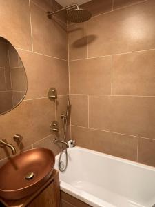 a bathroom with a sink and a bath tub at S1 Vilnius in Vilnius +31 photos