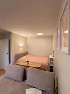 a small room with a bed and a table at S1 Vilnius in Vilnius