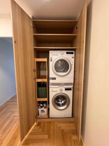 a washer and dryer inside of a closet at S1 Vilnius in Vilnius