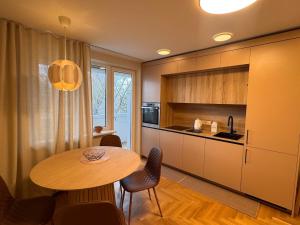 a kitchen with a table and chairs in a room at S1 Vilnius in Vilnius