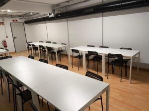 a group of tables and chairs in a room at Beddy Hostels in Madrid