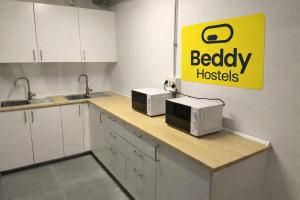 a kitchen with a counter with two microwaves on it at Beddy Hostels in Madrid