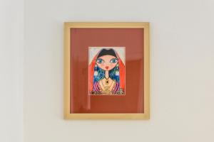 a painting of a woman on a wall at NG Guest House Ammentos in Olbia