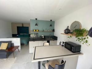 a living room with a table and a kitchen at Le Narlay in Le Frasnois